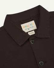 Front close view of uskees cotton drill overshirt with clear view of the collar, brand/size label and brand label