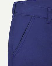 Front close view of Uskees cotton drill 'commuter' trousers for men in ultra blue showing belt loops, front pocket and brand label at waist