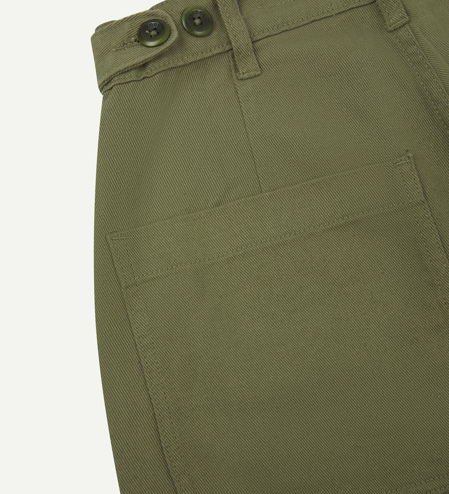 Close up shot of moss drill trousers from Uskees showing back pocket and waist band button adjusters