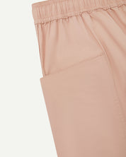 Close-up view of dusty pink organic cotton #5015 lightweight cotton shorts by Uskees showing elasticated waist and deep front pocket.
