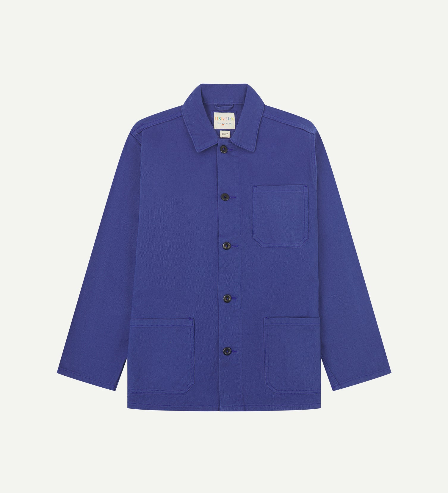 front flat shot of ultra blue coloured, buttoned drill overshirt from Uskees. Clear view of corozo buttons, chest and hip pockets.