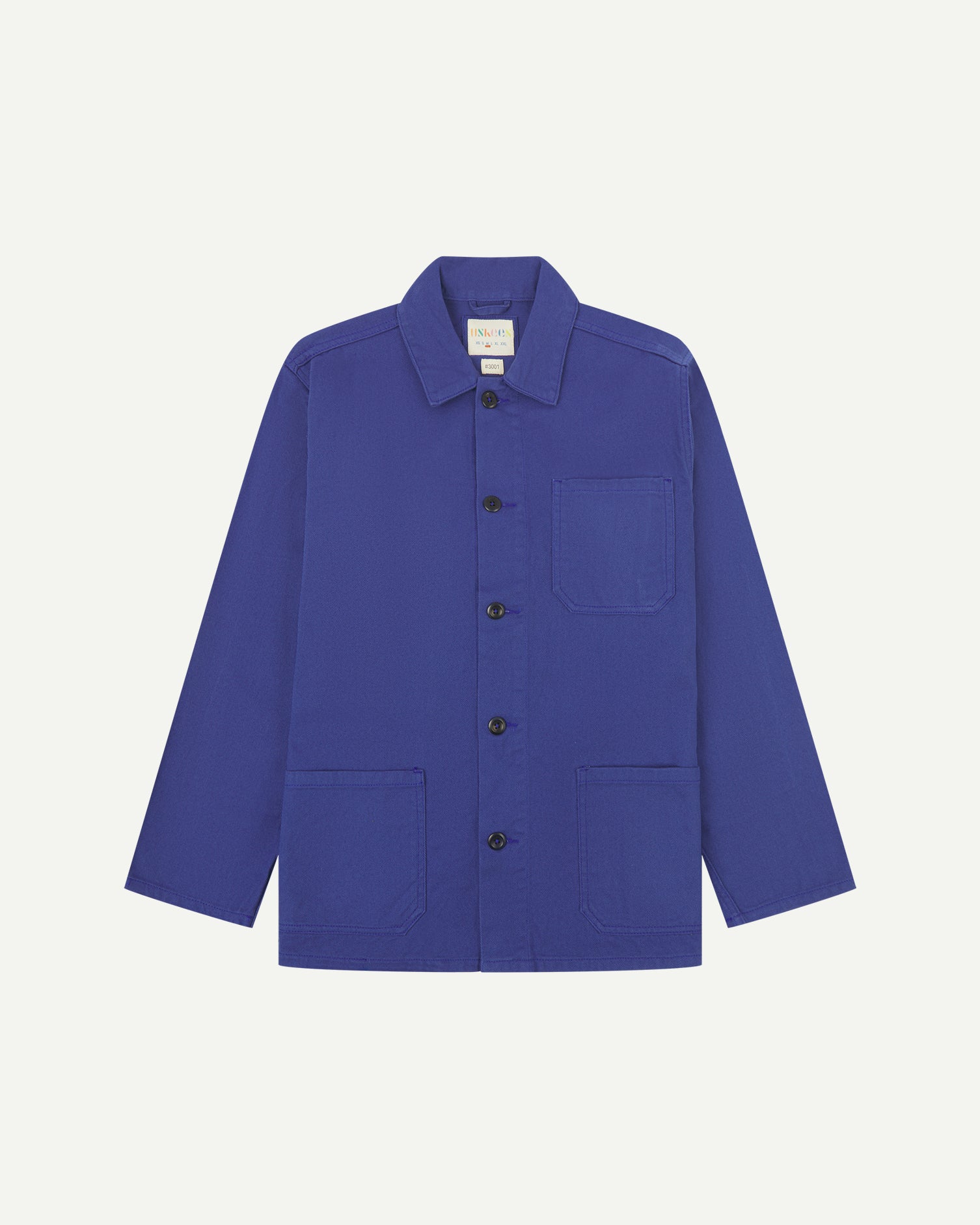 front flat shot of ultra blue coloured, buttoned drill overshirt from Uskees. Clear view of corozo buttons, chest and hip pockets.
