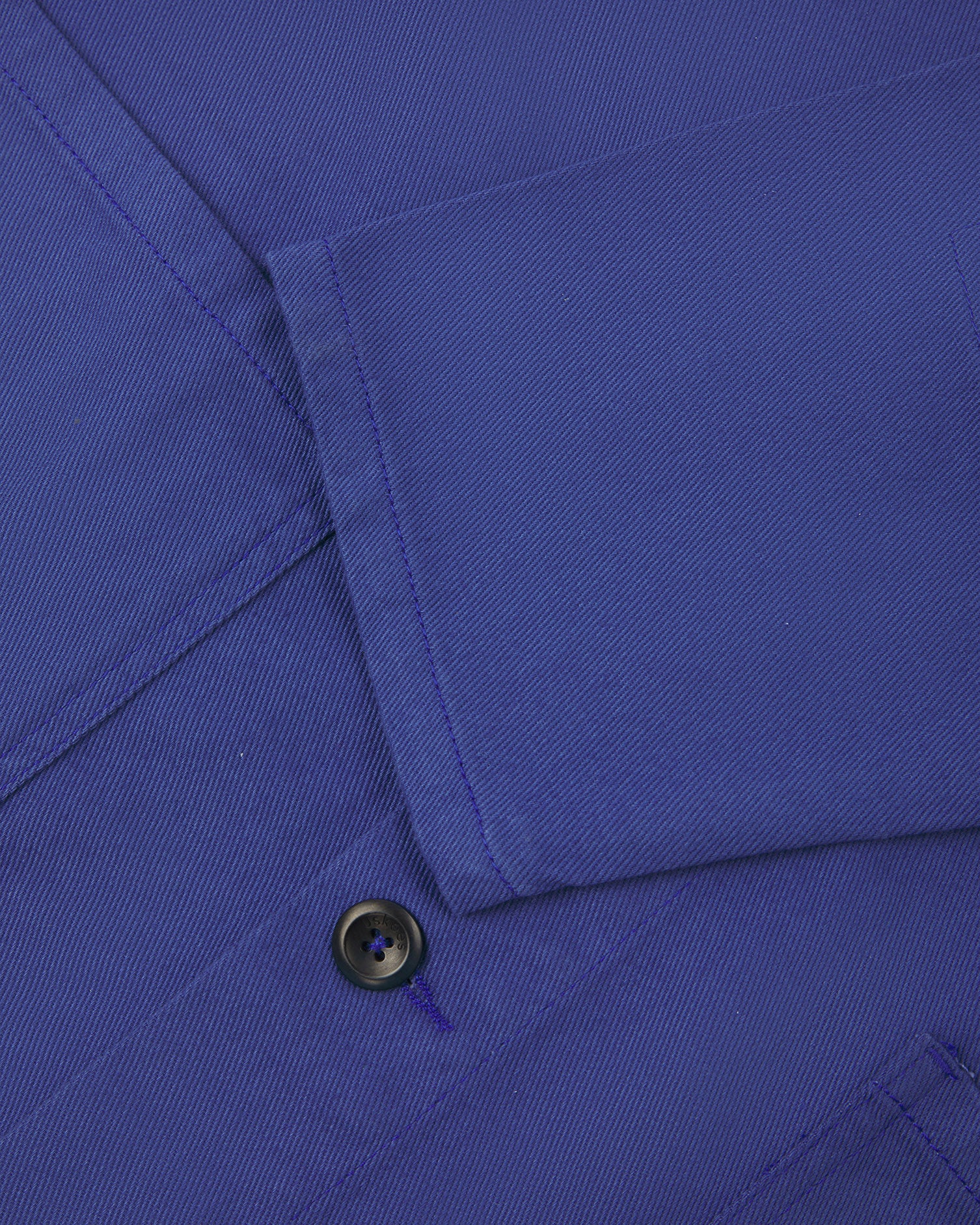 Close up shot of sleeve/front of ultra blue coloured, buttoned drill overshirt from Uskees.