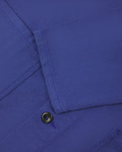 Close up shot of sleeve/front of ultra blue coloured, buttoned drill overshirt from Uskees.
