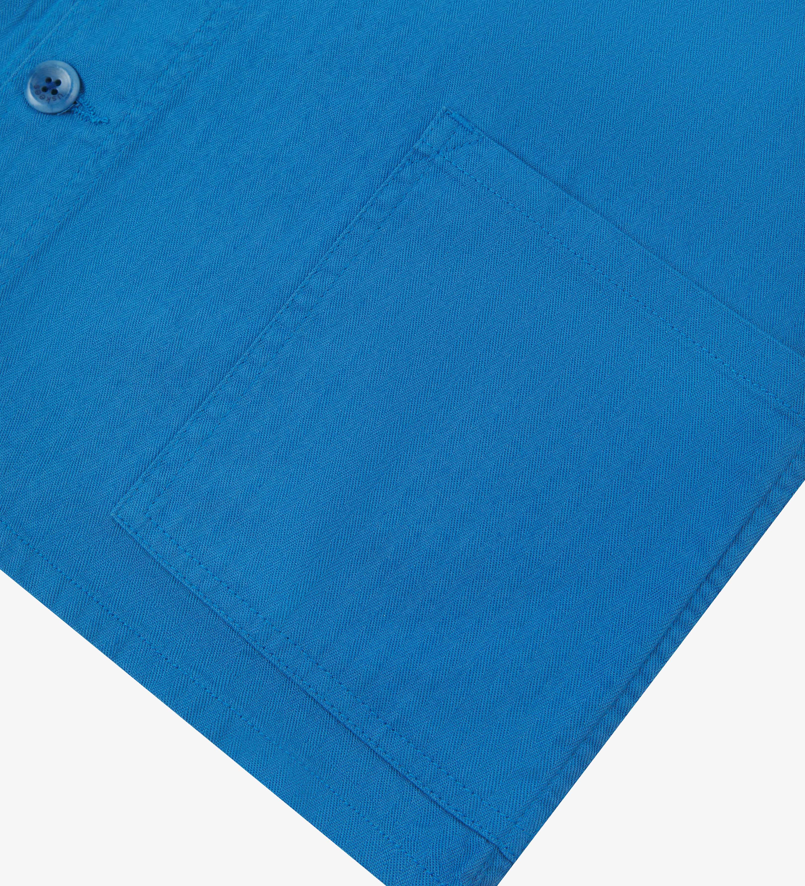 Close up view of Uskees 3041 opal-blue herringbone cotton signal jacket with focus on front pocket.