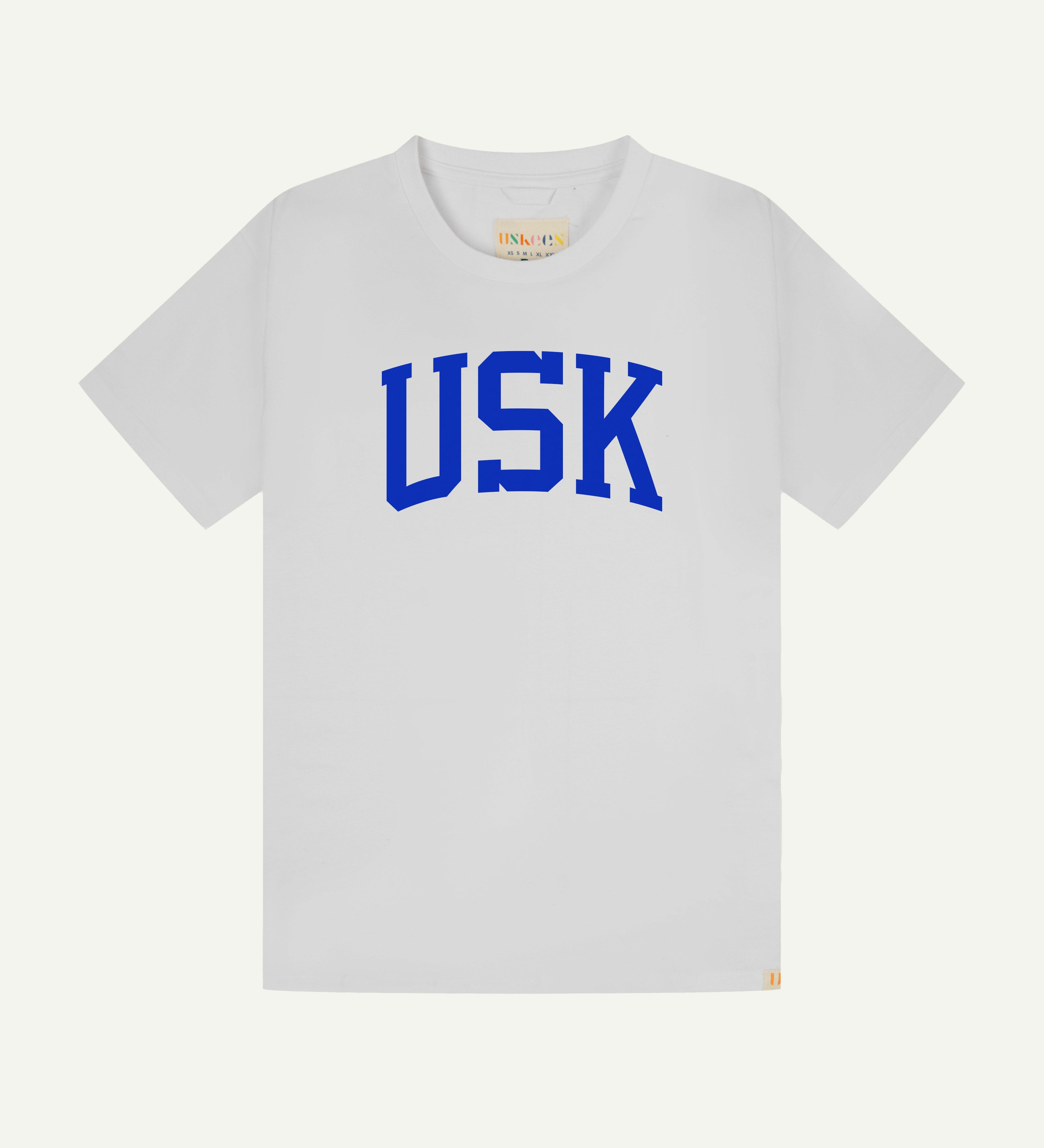 Flat shot of front of men's white short sleeve t-shirt with the signature USK logo on the front in blue.