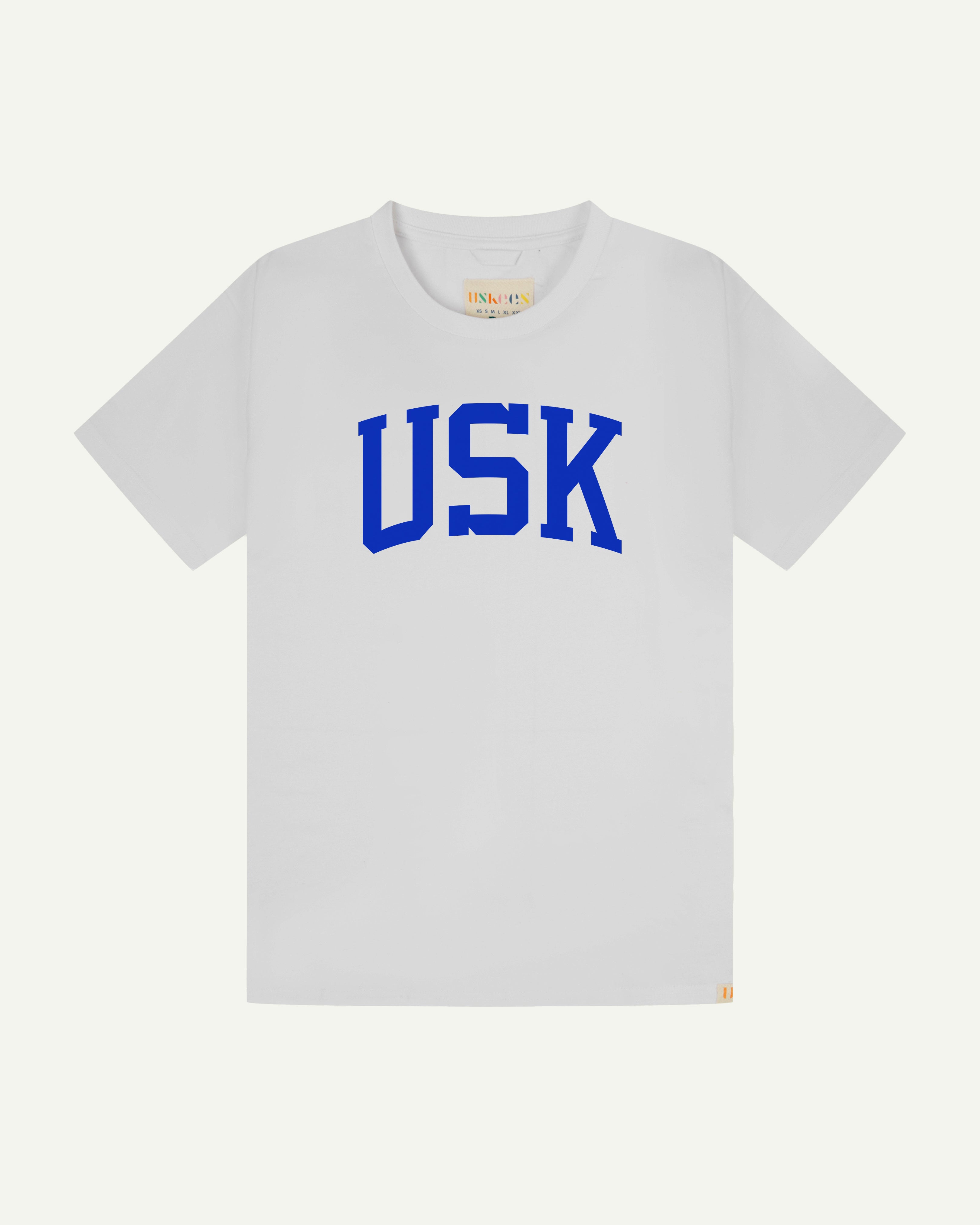 Flat shot of front of men's white short sleeve t-shirt with the signature USK logo on the front in blue.