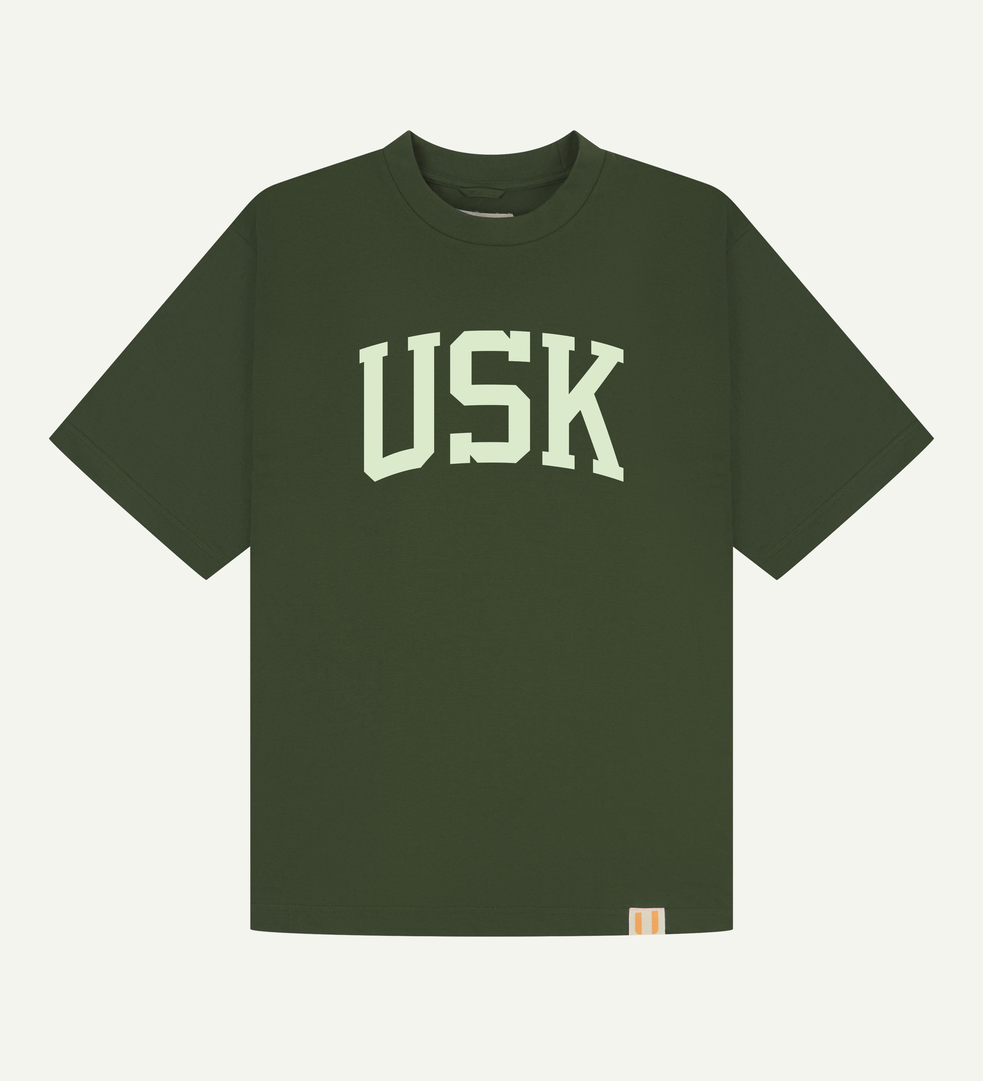 flat front shot of coriander green uskees signature t-shirt showing the cream USK logo.
