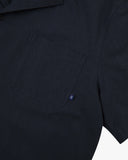 Front close up shot of an Uskees dark blue, button front, short sleeve shirt showing the front chest pocket.