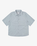 Front flat view of an Uskees light blue short-sleeve shirt presented on a white background