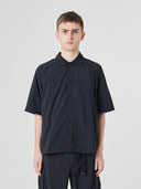 Front view of a male model wearing an Uskees dark blue short sleeved shirt and shorts outfit presented on a white background