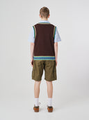 Back view of a male model wearing a brown tank top over a light blue sleeveless shirt with green cargo shorts on a white background