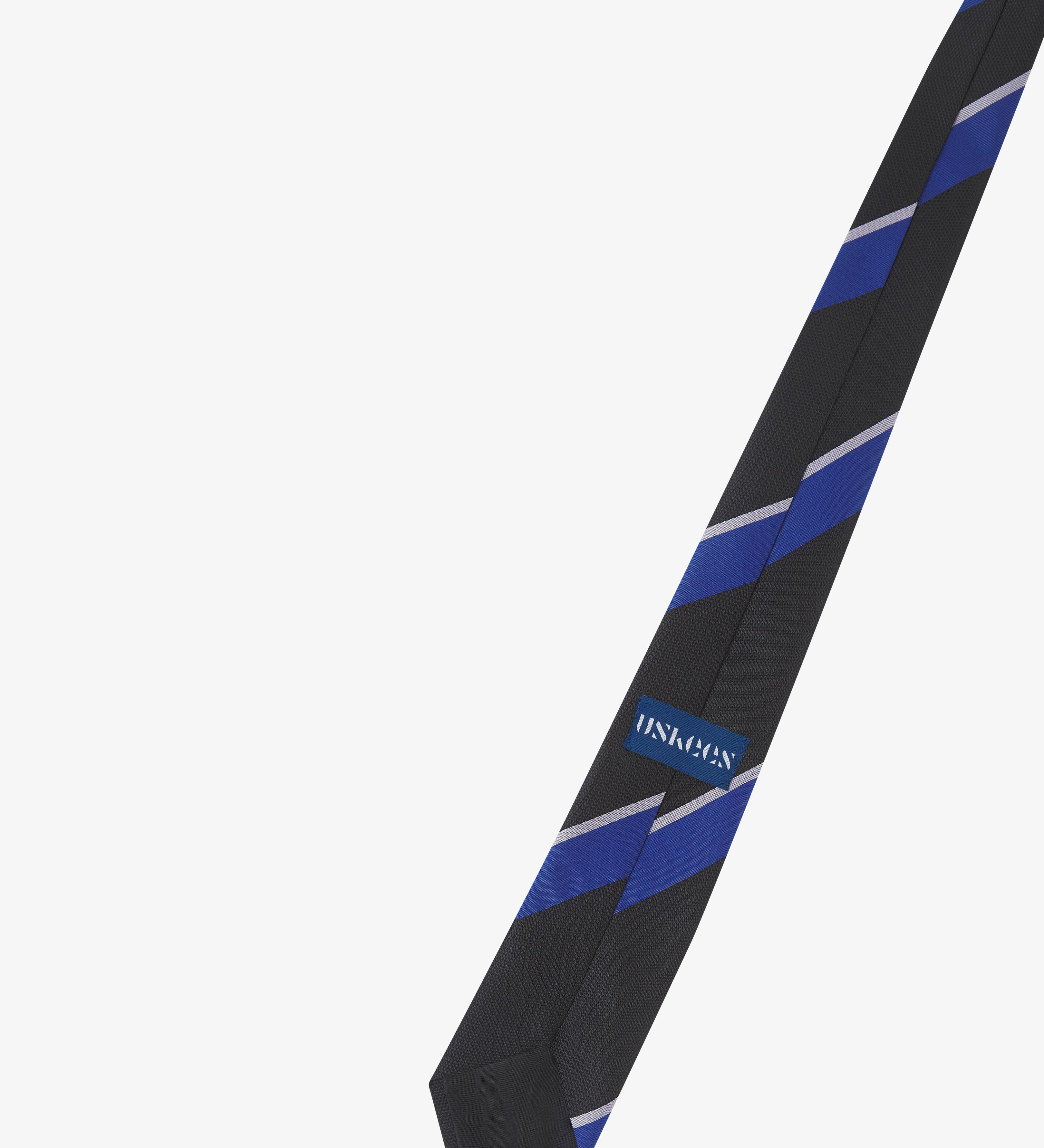 Back view of black,blue and grey striped tie showing the Uskees brand label