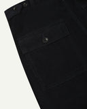 Close-up of Uskees midnight blue corduroy men's trousers showing the back pocket and button detail, presented on a white background