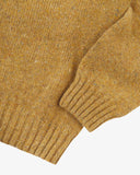Close up shot of Uskees butterscotch yellow sweater for men showing the ribbed hem and cuff.