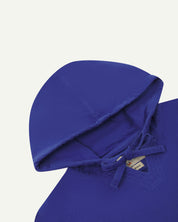 front flat close-up shot of uskees ultra blue men's smock showing hood and  part of neck label