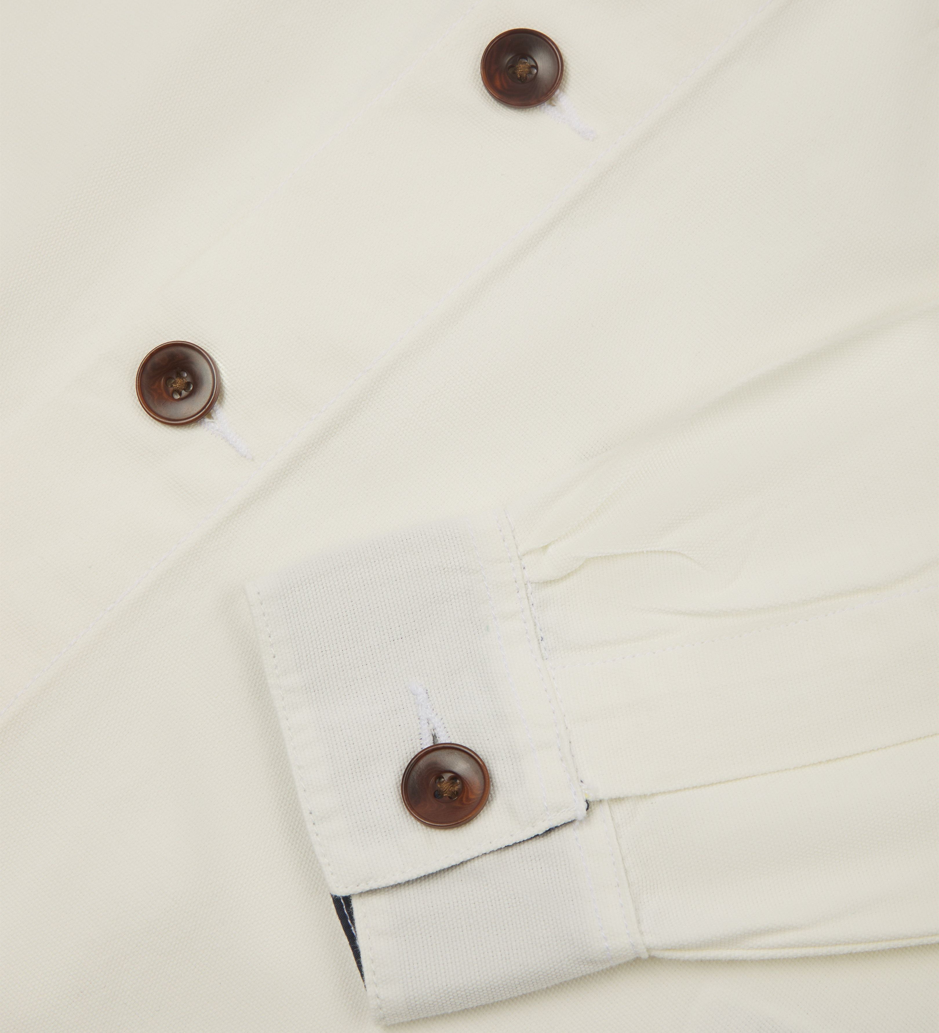 Close up view of cream buttoned 3003 workshirt from Uskees. Showing cuff and brown corozo buttons