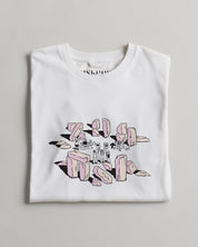 White Uskees t-shirt with a graphic design on a gray background presented folded up.