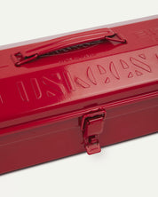 Close-up view of red Toyo steel toolbox with focus on Uskees branding, camber-top and rounded handle.