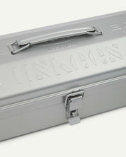 Close-up view of silver Toyo steel toolbox with focus on Uskees branding, camber-top and rounded handle.