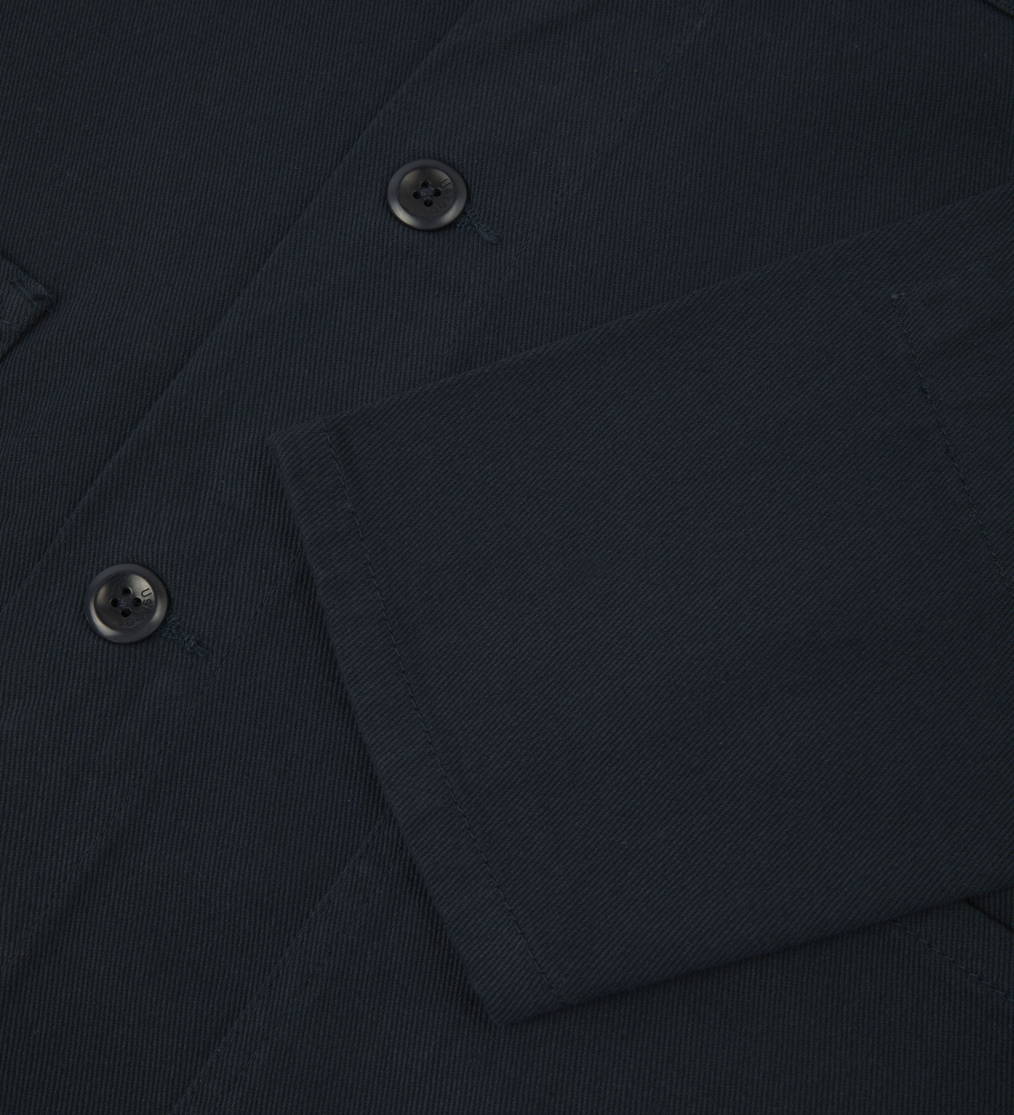 jacket from Uskees. Showing sleeve and blue corozo buttons.