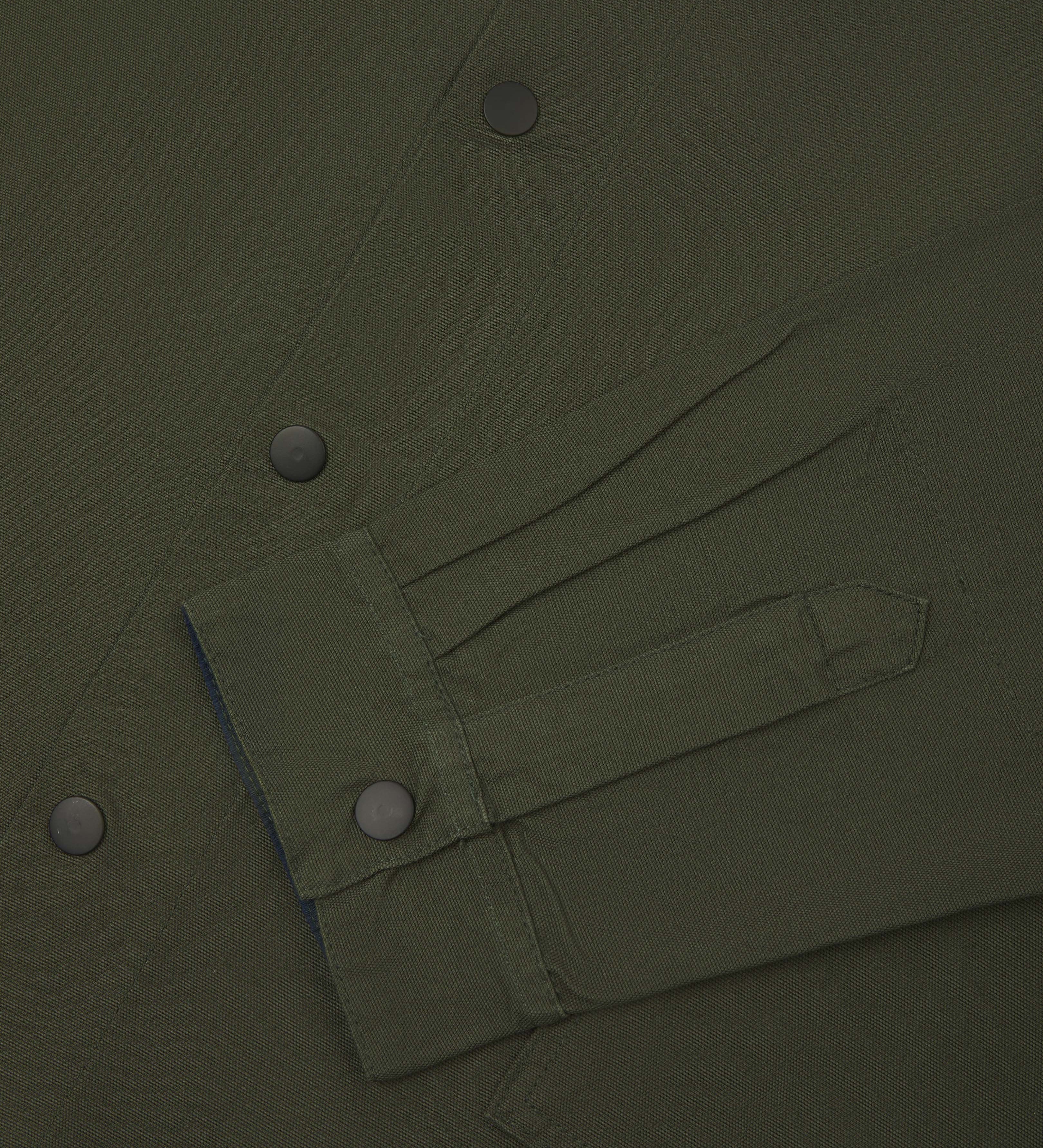 front flat shot of uskees dark green oversized coach jacket with popper fastening, showing cuff detail