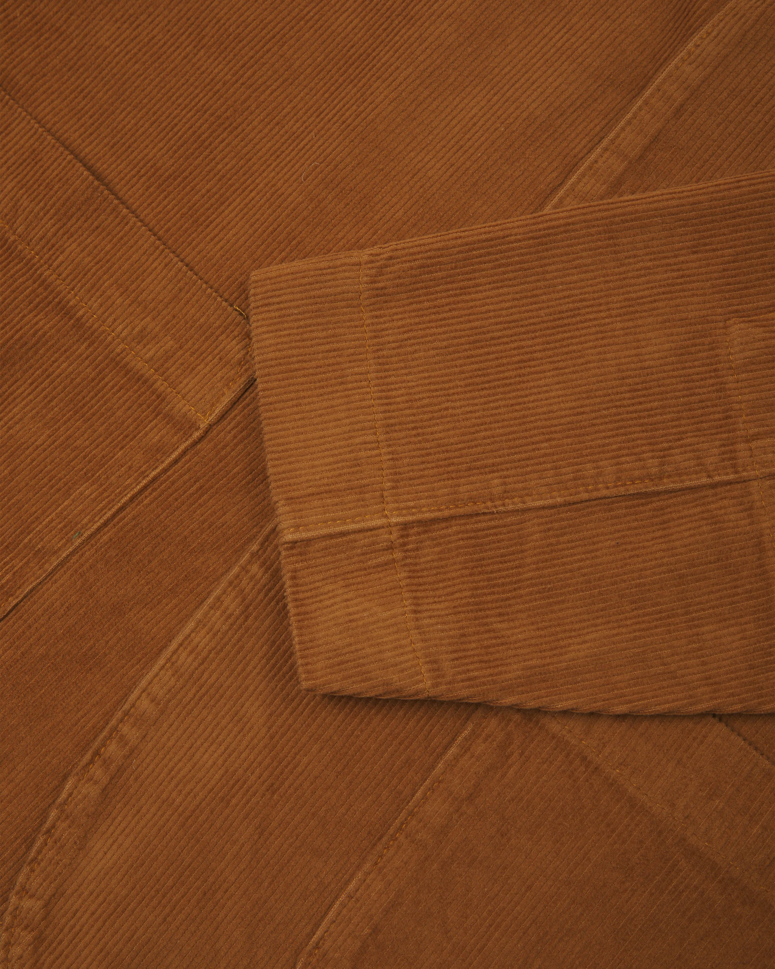 Close-up view of tan corduroy blazer from Uskees showing cuff detail.
