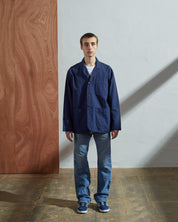 Full-length frontal view of model wearing #3006, navy unlined blazer paired with blue jeans. 3 Buttons fully secured showing simple silhouette.