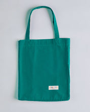 Full front hanging shot of Uskees #4002, small 'foam green' tote bag, showing double handles and Uskees woven logo.
