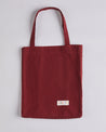 Full front flat shot of Uskees #4002, small 'merlot' tote bag, showing double handles and Uskees woven logo.